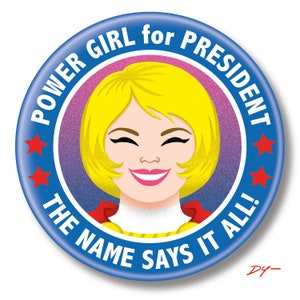 May include: A blue and red button with the text "POWER GIRL for PRESIDENT THE NAME SAYS IT ALL!" and a cartoon image of a woman with blonde hair and a red cape.