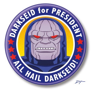 May include: A blue and yellow political campaign button with a cartoon image of Darkseid, a supervillain from DC Comics. The button reads "Darkseid for President" and "All Hail Darkseid!"
