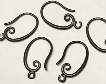 May include: Five black metal earring hooks with a decorative swirl design.