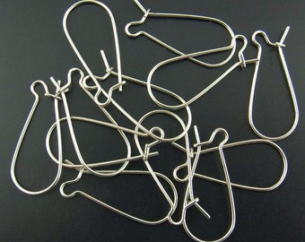 May include: A group of silver earring hooks, also known as ear wires, are shown in a pile. The hooks are made of metal and have a smooth, polished finish.
