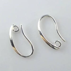 May include: Two silver earring hooks with a smooth, curved design. The hooks are made of metal and have a shiny finish.