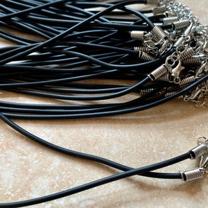 May include: A bulk pack of black elastic cord necklaces with silver spring ring clasps.