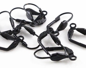 May include: Six black metal earring clips for non-pierced ears. The clips are shaped like a small rectangle with a curved wire loop on one side and a small wing-shaped piece on the other side.