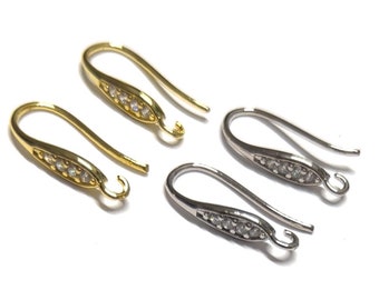 May include: Two pairs of earring hooks with a small row of clear rhinestones. One pair is gold and the other is silver.