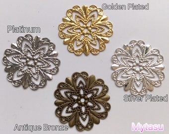 May include: Four decorative metal flower-shaped embellishments in different finishes: gold plated, silver plated, platinum, and antique bronze.