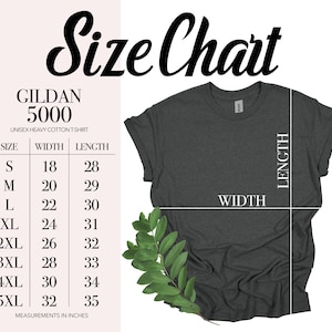 May include: A dark gray Gildan 5000 unisex heavy cotton t-shirt with a size chart. The chart shows measurements in inches for sizes S to 5XL, including width and length. A sprig of green leaves is in the lower left corner.