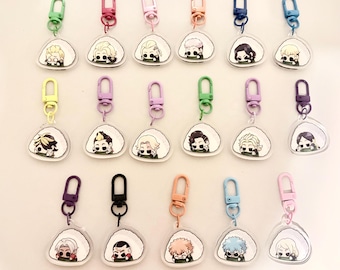 May include: A collection of seventeen acrylic keychains, each featuring a different illustrated character inside a triangular rice ball shape. Each keychain has a colored plastic lobster clasp, including shades of pink, blue, green, and black.