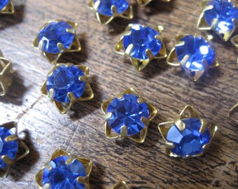 17 Vintage Small Blue Glass Star Embellishments w/brass settings, bright blue glass Rhinestones