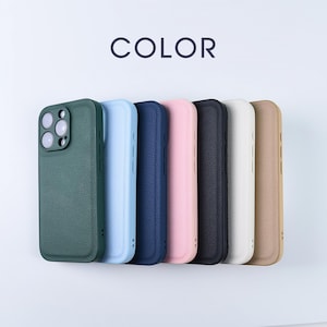 May include: A collection of seven smartphone cases with a textured finish, arranged in a row. The colours include dark green, light blue, navy blue, light pink, black, white, and tan. The word COLOR is printed in dark text above the cases.