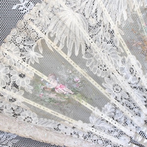 Large antique Brussels bobbin lace and gilded mother of pearl hand fan, Victorian cherubs image on gauze vignettes amongst large lace leaves