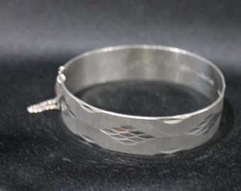 Vintage silver bangle, diamond design 1970/71  London  by M.P  Brit. Patent 1052231 NYMPH, inscription inside, opening with safety chain