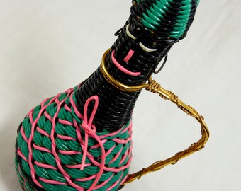 Kitsch plait plastic covered glass bottle with metal handle - hot pink + black + green African woman - French 50s 60s vintage