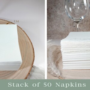 May include: A stack of 50 white paper napkins on a wooden surface. The napkins are folded and stacked neatly.