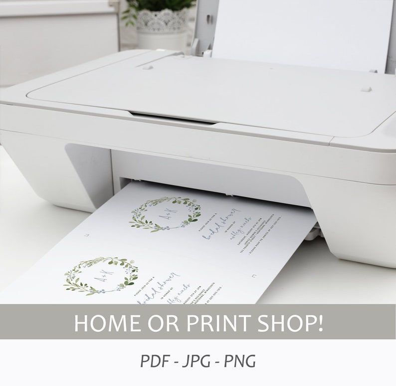 May include: A white printer with a sheet of paper coming out of it. The paper has two designs on it, both featuring a wreath of green leaves and blue flowers with the letters "A & K" in the center. The text "Bridal Shower" is printed on the paper. The text "Home or Print Shop!" is printed below the printer. The text "PDF - JPG - PNG" is printed below the text "Home or Print Shop!"