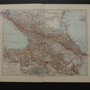 May include: An antique map of the Caucasus region, featuring detailed geographical information. The map is printed on aged paper, with text in German, and shows the Black Sea and surrounding areas. The map is open, revealing the full illustration.