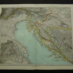 May include: Vintage map print showing a coastal region with detailed land features and a light blue sea. The map has a classic aesthetic, with faded colours and intricate line work, showcasing geographical details.