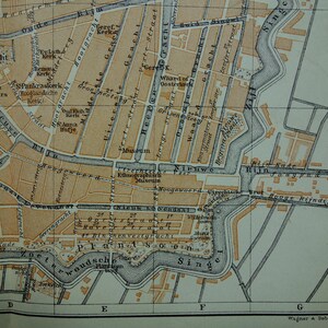 May include: A detailed vintage map of a city, featuring streets, canals, and buildings in shades of brown and beige. The map includes text labels and grid lines, with a watermark in the bottom right corner. The map is a historical document.