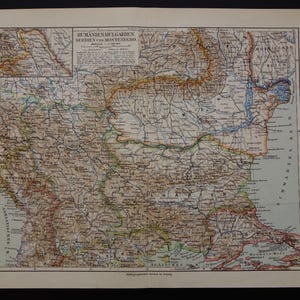 May include: An antique map of Romania, Bulgaria, Serbia, and Montenegro, with detailed geographical features. The map features a key in German and is printed on aged paper, showcasing historical cartography.