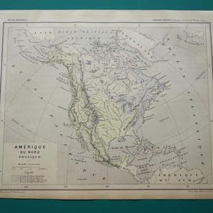 May include: An antique map of North America, titled "AMÉRIQUE DU NORD PHYSIQUE," with detailed geographical features. The map is in French, featuring shaded relief and labeled with various locations. The paper has a vintage, aged appearance.