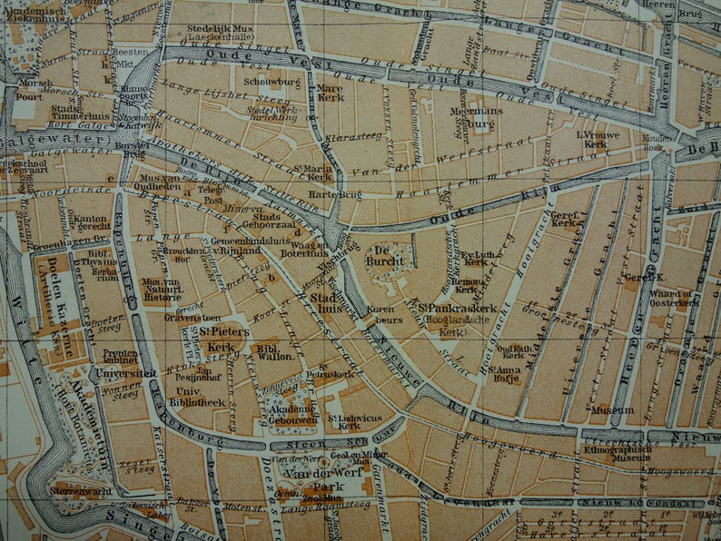 May include: A detailed vintage map of a city, likely Amsterdam, with streets, canals, and building outlines. The map is in shades of tan and brown, with text labels in a classic font. The map is a historical document.