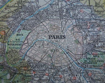 May include: A vintage map of Paris, France, with the city's name printed in bold letters. The map shows the city's districts, streets, and surrounding towns. The map is printed in black and white with some color accents.