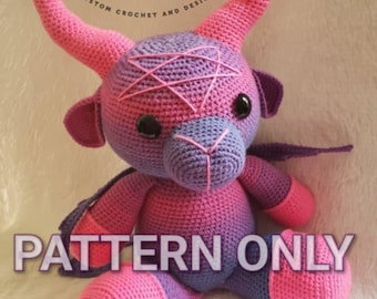 May include: A crocheted purple and pink bull with horns, a pentagram on its forehead, and the text "PATTERN ONLY" in large letters.