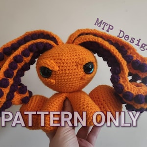 May include: Crochet pattern for an orange octopus with purple tentacles. The pattern is called "PATTERN ONLY" and is available for purchase.