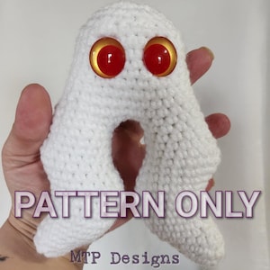 May include: Crochet pattern for a white ghost with red eyes. The pattern is called "PATTERN ONLY" and is by "MTP Designs".