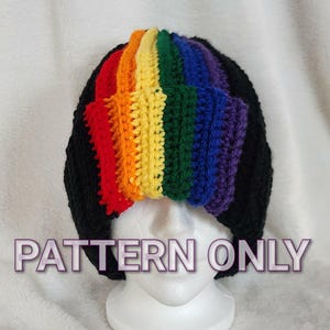 May include: A black crochet beanie with a rainbow stripe across the top. The text "PATTERN ONLY" is displayed across the front of the beanie. The beanie is displayed on a white mannequin head.
