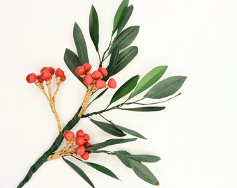 May include: A decorative floral stem featuring green leaves and clusters of red berries. The berries are attached to the stem with a natural-colored twine. The leaves are a deep green color, and the stem is a darker green.