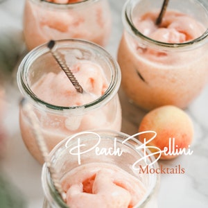 May include: Four glass jars filled with a pink peach puree drink, with a peach on the table and the text "Peach Bellini Mocktails" in white.