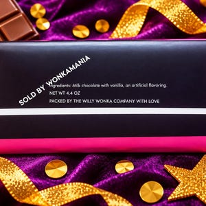 May include: A rectangular chocolate bar in a black wrapper with bright pink borders. The text reads: SOLD BY WONKAMANIA, Ingredients: Milk chocolate with vanilla, an artificial flavoring, NET WT 4.4 OZ, PACKED BY THE WILLY WONKA COMPANY WITH LOVE.