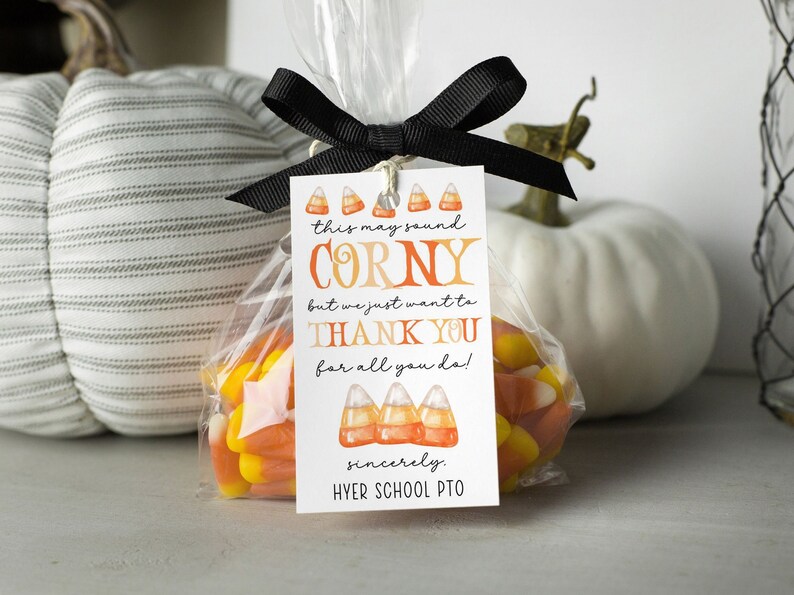 May include: A white gift tag with orange and yellow candy corn illustrations. The text reads "this may sound corny but we just want to thank you for all you do!" and "sincerely, HYER SCHOOL PTO".