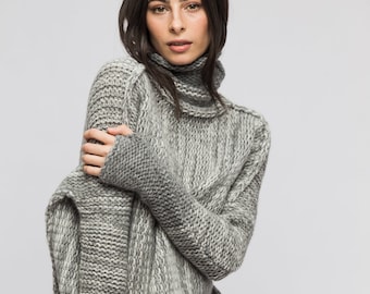 May include: A gray and white striped turtleneck sweater with a loose fit.