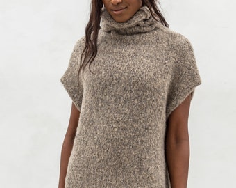 May include: A brown turtleneck sweater with short sleeves. The sweater is made of a soft, fuzzy material.