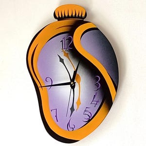 Può includere: Un orologio da parete surrealista con un design che si scioglie. Il quadrante dell'orologio è lavanda con lancette nere e numeri arancioni. La cornice dell'orologio è arancione e nera, con una parte superiore decorativa.