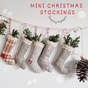 May include: Five mini Christmas stockings hanging from a string. The stockings are made of fabric and have different patterns, including plaid, floral, and a solid color. The stockings are decorated with lace trim. The text "MINI CHRISTMAS STOCKINGS Sewing Pattern" is at the top of the image.