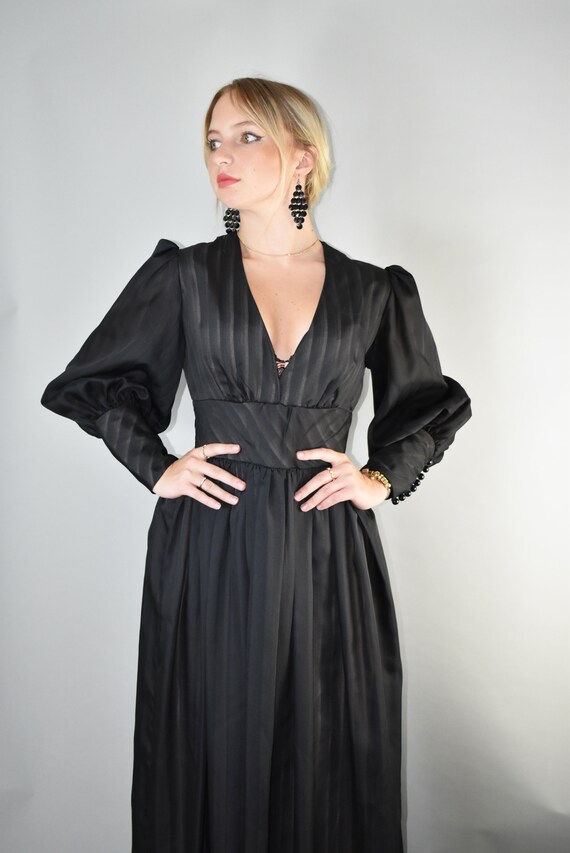 Deep plunge neckline 70's black maxi dress leg of
