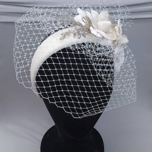 Ivory padded velvet headband fascinator with velvet side flower design, beaded sprigs  & veiling.