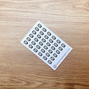 May include: A sheet of white paper with black and white stickers of a train. The stickers are arranged in rows and columns. The text "10thbridgepaper.co.uk" is printed in the bottom right corner.