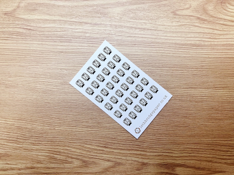 May include: A sheet of white paper with black and white stickers of a train. The stickers are arranged in rows and columns. The text "10thbridgepaper.co.uk" is printed in the bottom right corner.
