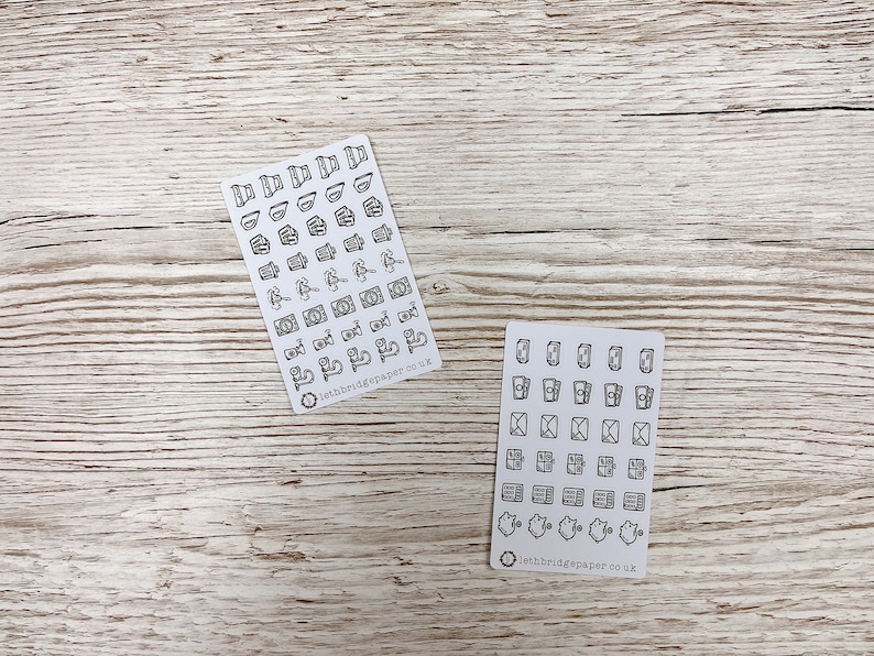 May include: Two sheets of white sticker paper with black outline icons. The first sheet has icons of various objects, including a camera, a cup of coffee, a book, and a plant. The second sheet has icons of various mail-related objects, including envelopes, stamps, and mailboxes. Both sheets have the text "lethbridgepaper.co.uk" at the bottom.