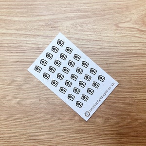 May include: A sheet of white paper with 49 black and white washing machine icons. The paper has the text "lethbridgepaper.co.uk" in the bottom right corner.