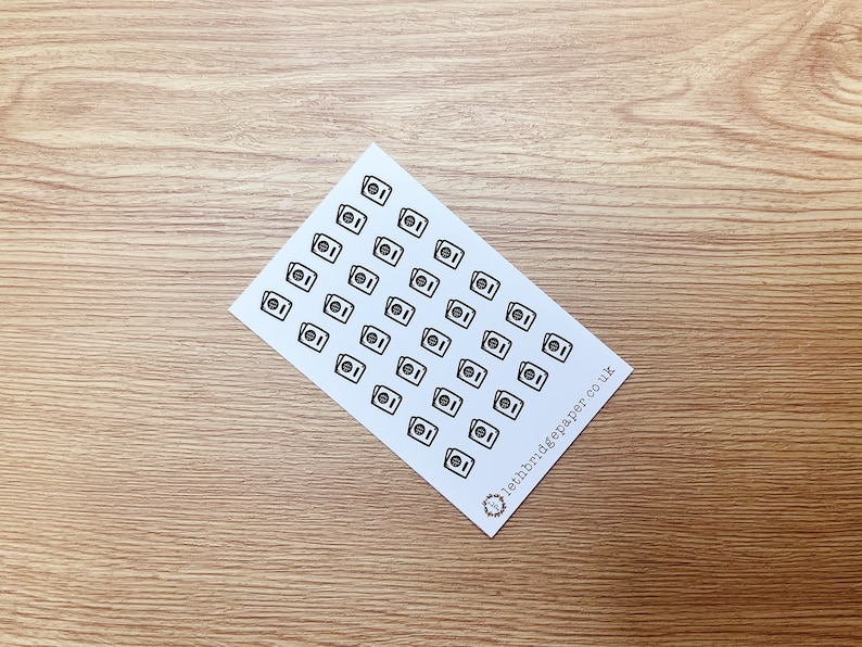 May include: A sheet of white paper with 49 black and white washing machine icons. The paper has the text "lethbridgepaper.co.uk" in the bottom right corner.