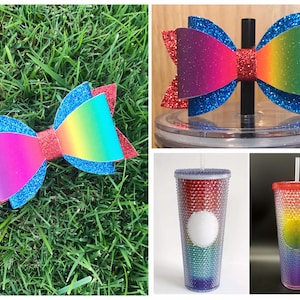 May include: A set of three rainbow-colored, glitter-covered tumblers with a red lid and a straw. The tumblers are decorated with rhinestones. The set also includes a rainbow-colored glitter bow with a red center.