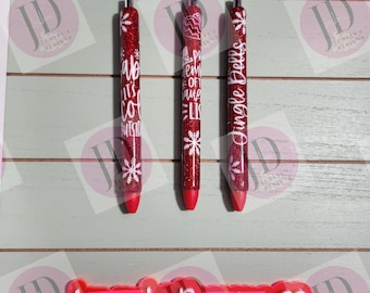 Set of 3 red glitter with white decals. Baby its cold outside/jingle bells/ proud member of the naughty list.  Glitter Gel pens/ refillable