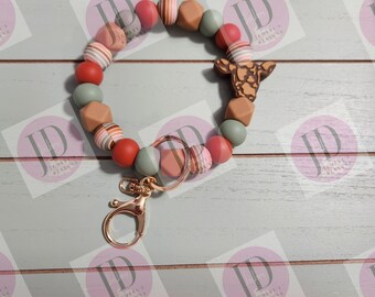 Beaded Bangle Cow head and spiral earthtone print beads. Sage green and rust. Keychain/beaded Bangle for her/brown cow wristlet Bangle