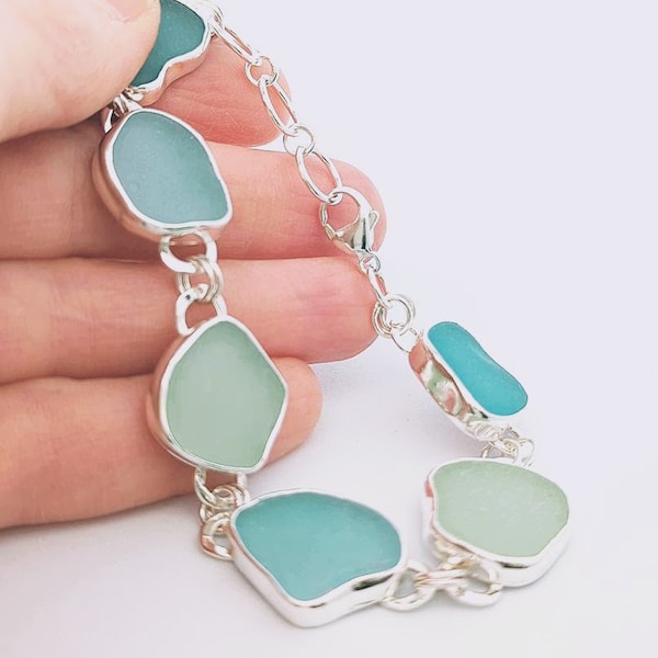 Sea glass bracelet. Multiple pieces of genuine sea glass are bezel set in fine silver creating an ocean of color. Lobster clasp closure