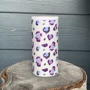 May include: White insulated can cooler with a purple and blue leopard print design.