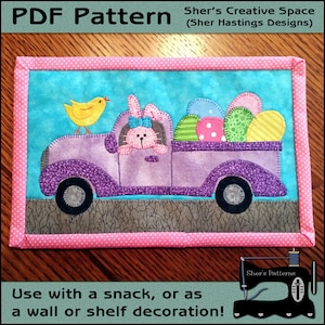 May include: A purple pickup truck with a bunny rabbit in the driver's seat. The truck is carrying a load of colourful Easter eggs. A yellow chick sits on the back of the truck. The image is a PDF pattern for a quilted wall hanging.